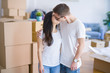 © Krakenimages.com - Young beautiful couple kissing wearing glasses standing at new home around cardboard boxes
