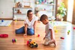© Krakenimages.com - Beautiful teacher and toddler boy playing with tractor and cars at kindergarten