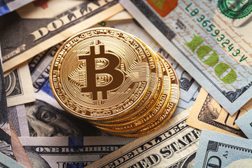 golden bitcoin coin on us dollars close up. Electronic crypto currency