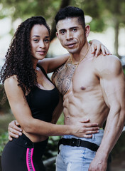 Vertical photo of a young couple of different ethnicities in good shape