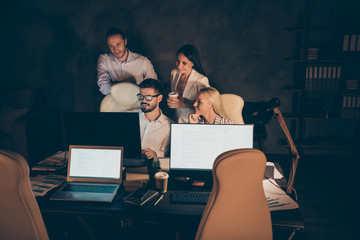 Wall Mural - Nice attractive cheerful skilled experienced hardworking coworkers partners leaders experts specialists creating new launch startup at night at work place station dark room indoors