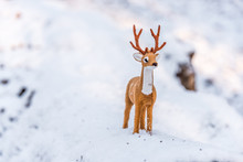 Toy Deer Doll In A Snowy Winter Forest