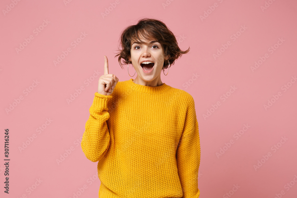 Excited young brunette woman girl in yellow sweater posing isolated on ...