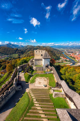 Wall Mural - Celje Old castle (Celjski Stari grad), amazing aerial view of medieval fortification and town of Celje in Lasko valley in Julian Alps mountains, Slovenia, Styria. Outdoor travel background, vertical