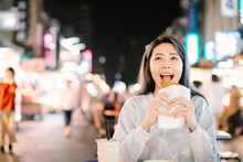 Asian Woman Enjoy  Chicken Fillet With Street Food In  Night Market