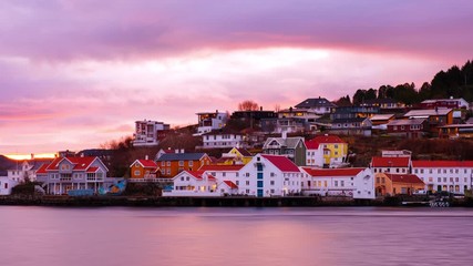 Wall Mural - Kristiansund, Norway. View of city center of Kristiansund, Norway during the cloudy morning at sunrise with colorful sky. Time-lapse of port with historical buildings