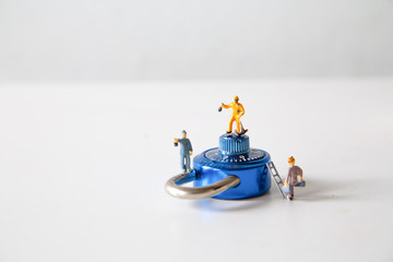 the images are miniature people try to unlock metal security lock key lock, concept: hacker password