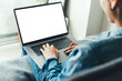 © panitan - mockup image blank screen computer with blank white background for advertising text,hand man using laptop contact business search information on desk at home office.marketing and creative design