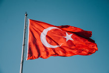 Turkish Flag On Sky Background. Waving Red Flag. Turkish Patriotism. Turkey Day. Cumhuriyet Bayramı. Izmir, Turkey. National Turkish Flag.
