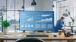 © Gorodenkoff - Shot of a Desktop Computer in the Creative Modern Office. Monitor Screen Shows Company Growth Data with Graphs, Charts, Software UI. In the Background Young Professional Using Smartphone.
