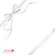 Silver or white ribbon with bow tied to corner with a knot. Gift.