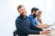 © yurolaitsalbert - cheerful employee sitting at his Desk in the office