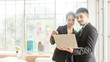 © MIA Studio - Beautiful asian business man and woman looking in laptop in office and happy.Asian business adviser meeting to analyze and discuss the situation.Investment Consultant,Financial Consultant.