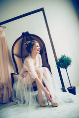 bride's morning. beautiful girl trying on elegant wedding shoes