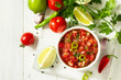 © elena_hramowa - Traditional mexican homemade salsa sauce and ingredients on a white wooden table. Top view on a flat background. Copy space.