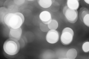 Blurred lights dark gray background. Abstract bokeh with soft light. Shiny festive christmas texture