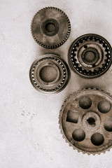 Canvas Print - top view of aged metal round gears on grey background