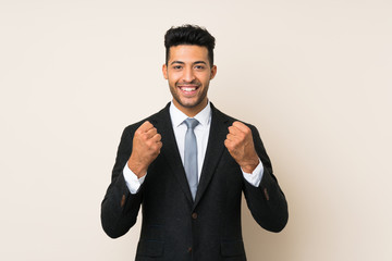 Wall Mural - Young handsome businessman man over isolated background celebrating a victory