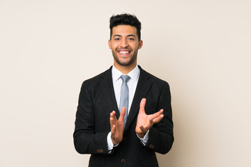 Young handsome businessman man over isolated background applauding