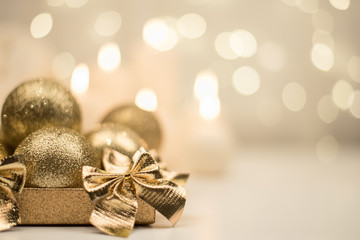 Box with golden christmas ball on golden star bokeh background