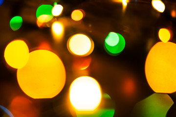 New Year pattern with bokeh lights. Christmas background with defocused colored lights. Blurred colourful lights.