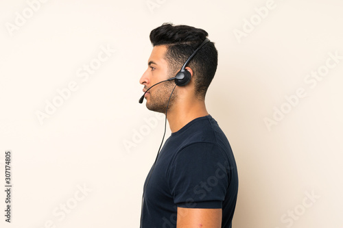 Fotografía Young handsome man over isolated background working with headset