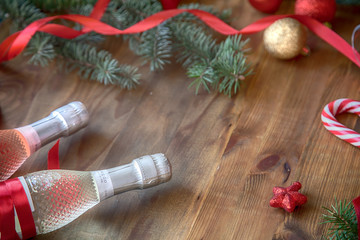 Champagne and Christmas decor on a  wooden background