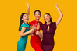 © Prostock-studio - Three Models Clinking Glasses Having Fun Standing Over Yellow Background