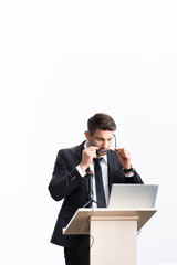 Wall Mural - businessman in suit standing at podium tribune and wearing glasses during conference isolated on white