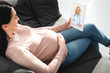 © LIGHTFIELD STUDIOS - attractive pregnant woman having online consultation with female doctor on digital tablet