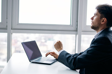 Wall Mural - businessman working on his laptop in office