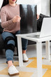 © LIGHTFIELD STUDIOS - cropped view of woman showing x-ray of leg on online consultation with doctor on laptop