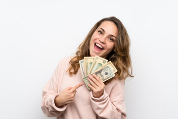 Wall Mural - Young blonde woman taking a lot of money