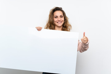 Wall Mural - Young blonde woman holding an empty white placard for insert a concept