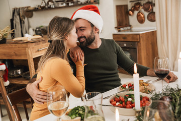 Sticker - Smiling beautiful young couple celebrating Christmas together