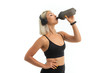© Ivan Traimak - blonde girl in a sports uniform drinks water listens to music on a white background