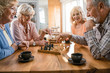 © Drazen - Group of happy seniors playing chess at home.