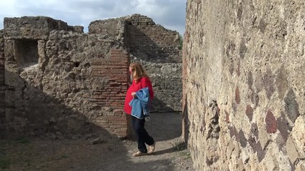 Wall Mural - Italy, Pompeii, archaeological area, remains of the city buried by the eruption of ashes and rocks of Vesuvius in 79. Tourist turns in the ruins