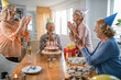 © Drazen - Group of cheerful seniors having fun while celebrating man's birthday at home.
