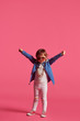 © serhiilysenko - funny little girl in a beach hat and sun glasses on a pink background, studio shooting