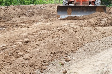 Canvas Print - tractor push clot soil after pour from truck