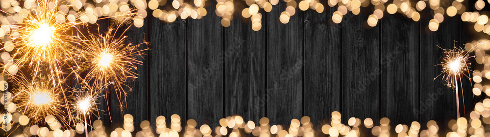 Silvester background banner panorama long- Frame made of sparklers and bokeh lights on rustic wooden texture, with space for text - obrazy, fototapety, plakaty 
