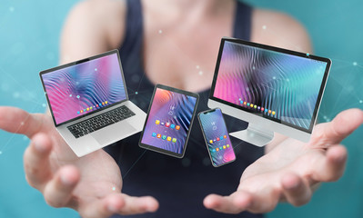 Wall Mural - Woman connecting modern smartphone tablet laptop and computer 3D rendering