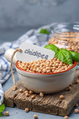 Wall Mural - Dry chickpea seeds in a ceramic bowl.