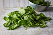 © Westend61 - Fresh spinach leaves on wood, colander