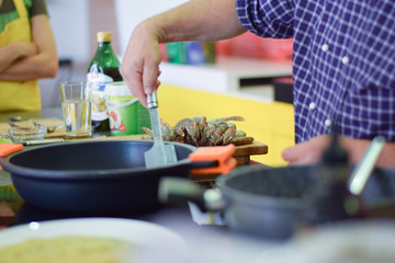 Poster - Chef's hand stirring meal in a deep pot