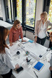 © Westend61 - Businesswomen having a meeting in office with blueprints on table