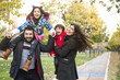 © FotoAndalucia - Autumn image of happy four members family in public park
