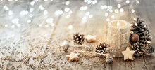 White Christmas Candle On Rustic Wooden Boards -  Decoration With Natural Elements, Twigs, Pine Cones And Cookies  -  Advent Banner, Panorama With Magic Bokeh Lihgts