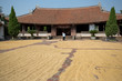 Drying rice on court yard of traditional Vietnamese building, Near Hanoi, Vietnam